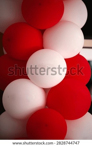 A close-up composition of red and white balloons stacked together creates a striking, festive arrangement with smooth, rounded shapes and contrasting colors. This design captures the festive atmosphere of the Republic of Indonesia’s Independence Day celebrations.