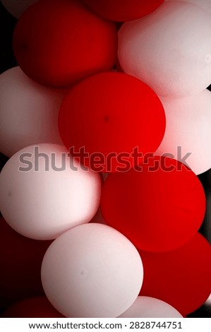 A close-up composition of red and white balloons stacked together creates a striking, festive arrangement with smooth, rounded shapes and contrasting colors. This design captures the festive atmosphere of the Republic of Indonesia’s Independence Day celebrations.
