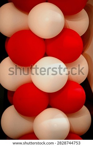 A close-up composition of red and white balloons stacked together creates a striking, festive arrangement with smooth, rounded shapes and contrasting colors. This design captures the festive atmosphere of the Republic of Indonesia’s Independence Day celebrations.