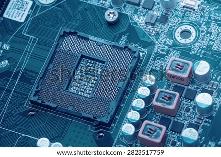 Close-up of a computer motherboard with CPU socket, microchips and electronic components, highlighting modern hardware and digital technology.