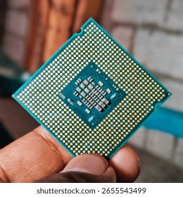 Close-up of a computer processor held in hand, technology concept