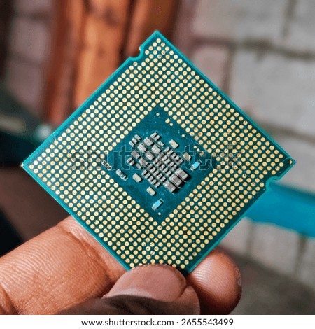 Close-up of a computer processor held in hand, technology concept