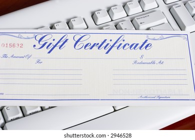 close-up of a computer white keyboard with gift certificate - online shopping