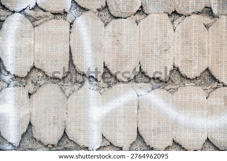Close-up of concrete mortar with a distinct patterned imprint from missing tiles.