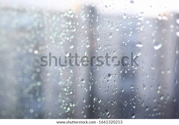 Close-up\
condensate on window, drops on glass. Background raindrops flow\
down car glass. Sad mood, rain hits window. Shower outside windows.\
Rainy mood in autumn. Spring on\
windshield