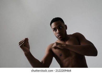 Close-up Of Confident Young Black Male Boxer Practicing Boxing Poses In Studio.