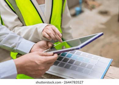 closeup construction engineer with interior design looking at tablet screen for color chart software
