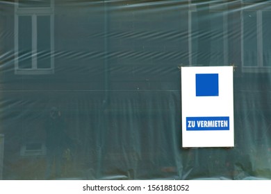 The Close-up Of A Construction Site Tarp With A Sign For Rent.

