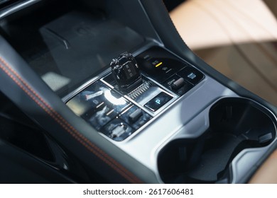 close-up of a contemporary automatic gear shift knob in a glossy car console, highlighting convenience, style, and interior automotive design.