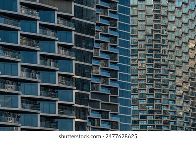 Close-up of contemporary glass building facades with reflections, showcasing modern urban architecture and geometric design in Dubai city, UAE. Abstract architecture background - Powered by Shutterstock