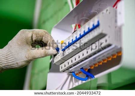 Close-up of the control panel circuit breaker. An electrician tests old wiring and the installation of switches and electrical systems in homes and buildings.