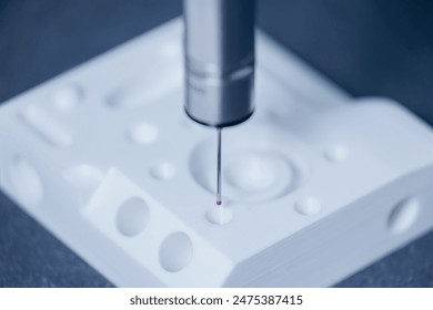 Closeup coordinate measuring machine probe CMM with sensor control quality of plastic parts from 3D printing. - Powered by Shutterstock