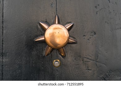 Closeup Of A Copper Doorknob With A Small Peephole Under It