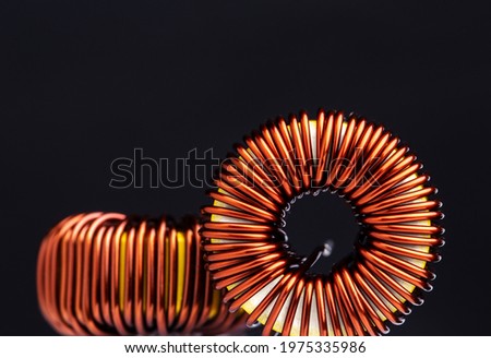 Close-up of copper wire coil on black background.