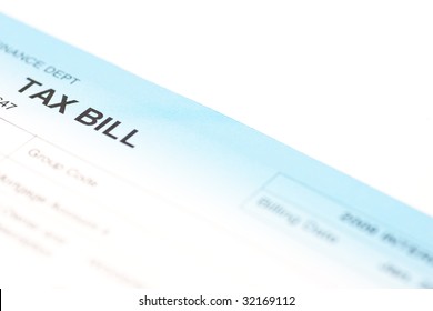 Closeup Of The Corner Of A Tax Bill, Isolated On White.