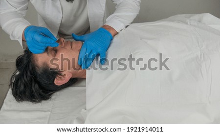 close-up of a corpse being autopsied possibly deceased from covid-19