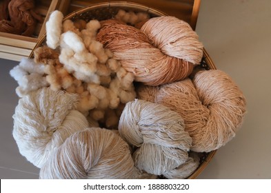 Closeup Of Cotton Thread Rolls And Dry Cotoon In Bamboo Basket Preparing For Cloth Weaving.