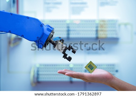 Close-up CPU chipset processor on hand human for sending to automation robot for upgrade efficiency to work on smart factory, blue tone color background, industry industry 4.0 concept