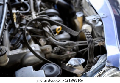 Close-up Of Cracked Car Engine Drive Belt.