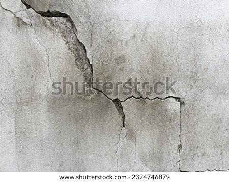Close-up of cracked concrete wall. Cracked concrete should be fixed.