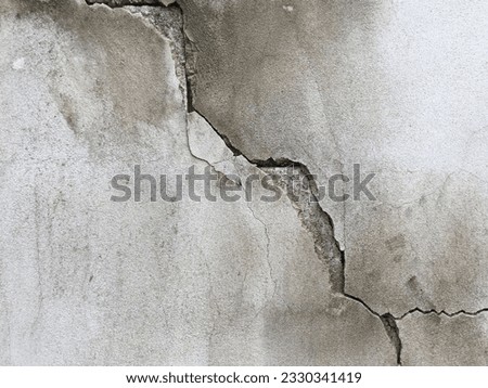 Close-up of cracked concrete wall. Cracked concrete should be fixed.