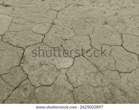 Close-up of cracked dry soil, symbolizing drought and climate change. Earth texture, environmental crisis, arid land, barren surface, soil erosion, global warming effect, dry ground. Dehydration,