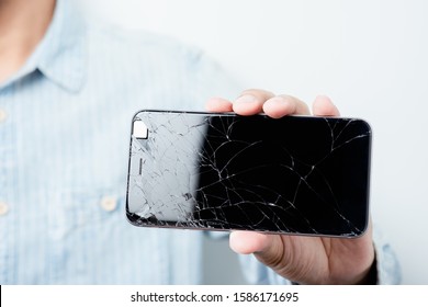 Closeup Cracked Screen On Broken Smart Phone.