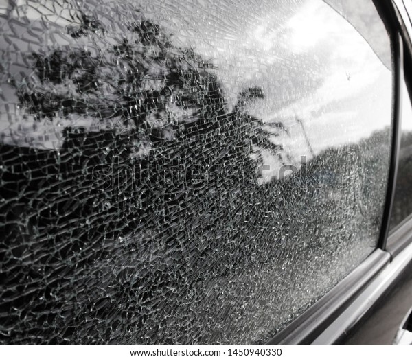 Close-up of\
cracked windshield. Damage glass\
texture.