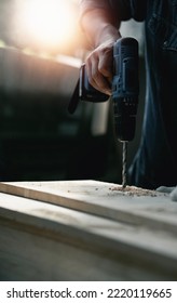 Closeup Craftman Hands Using Electronic Drill At Shop.