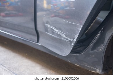 Close-up Of Crashed Cars Side Area With Scratched, Car Paint Stripping, Deep Scratches On A Silver Car With Front Rear Door, An Accident That Has Peeled Off