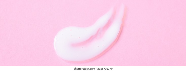 Close-up Cream Moisturiser Smear Smudge Wavy Texture On Pink. Background With Copy Space Horizontal Banner Format. Skin Care Beauty Product