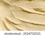 Close-up of creamy vanilla ice cream texture with smooth swirls, showcasing rich and indulgent dessert