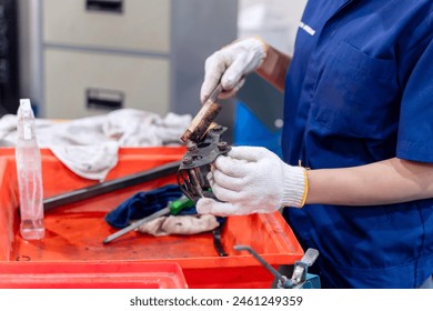 Closeup and crop Construction worker, Engineer wearing uniform working clean work piece in industrial workshop.