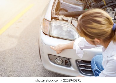 Closeup And Crop Sufferer Woman Point Out The Damage On Her Car With Sun Flare Background.