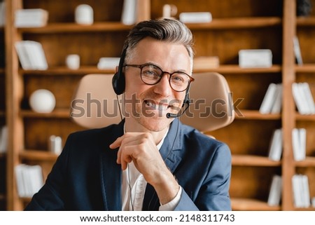 Closeup cropped caucasian mature middle-aged businessman it support hotline helpline worker employee in headset earphones working remotely, consulting on videocall clients customers