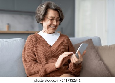 Closeup cropped front view photo of senior old elderly caucasian woman grandmother using smart phone cellphone for e-banking e-commerce, surfing social media online at home - Powered by Shutterstock