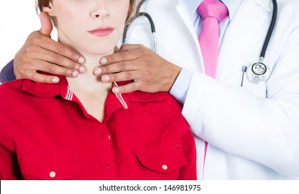 A close-up cropped image of a doctor performing physical exam, palpation of the thyroid gland. Male doctor and female patient, isolated on a white background 