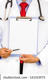 Close-up Cropped Image Of A Male Doctor Holding A Chart  With Copy Space Offering To Sign It.