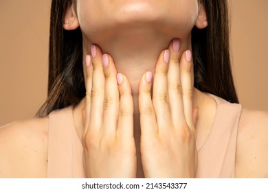 Closeup Cropped Image Of A Woman Has A Thyroid Disorder. Sore Throat. Inflamed Glands.