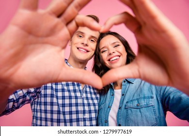 Close-up cropped low below angle view portrait of nice sweet charming lovely tender attractive cheerful positive optimistic couple soulmate in heart shape isolated over pink pastel background