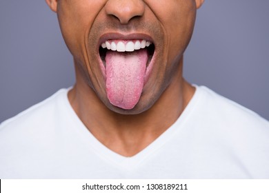 Close-up cropped portrait of his he handsome attractive well-groomed virile funky guy wearing white shirt showing tongue out isolated over gray violet purple pastel background