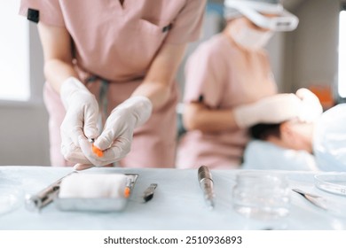 Close-up cropped shot of unrecognizable nurse assistant removing cap from needle of syringe, preparing to operation at hospital. Surgery doctor preparing syringe medicine for procedure in clinic - Powered by Shutterstock