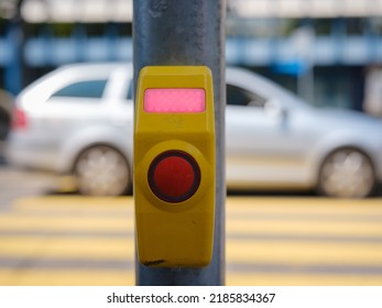 Close-up of a crosswalk signal button taken at a pedestrian controlled crossing. A call button allowing the passage of light.