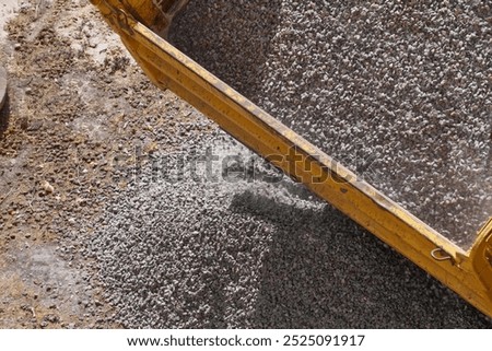 Close-up of crushed stone unloading at a construction site - detailed image of the process of unloading materials for construction.