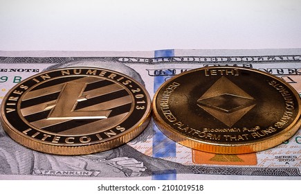 A closeup of Crypto coins LTC and ETH on 100 US dollar on isolated white background