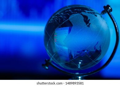 Close-up Crystal globe with a computer screen inside and a dark blue background