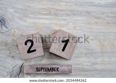 closeup cube calendar for september on a wooden background with copy space