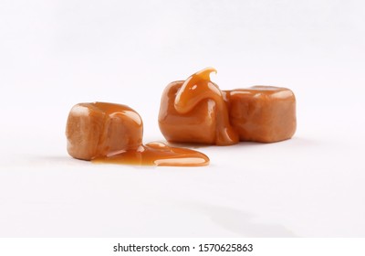 Closeup Cube Toffee 3 Pieces Caramel Candies And Caramel Sauce On A White Background