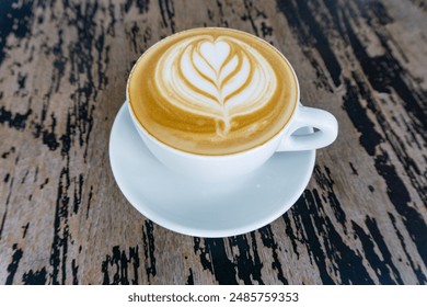 Closeup of a Cup of Cappuccino with Latte Art on a Wooden Table. Closeup of a Cup of Cappuccino with Latte Art on a Wooden Table. - Powered by Shutterstock