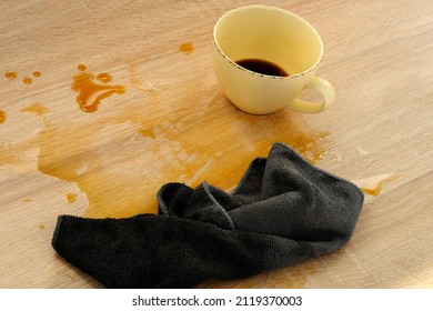 Closeup Of Cup Of Coffee, Tea Suddenly Spills, Hot Liquid Spilled On The Table, Floor, Concept Of Bad Luck, A Hard Day, Careless Handling Of Dishes, An Accident At Workplace